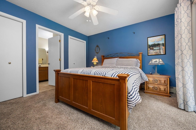 bedroom featuring light carpet, a baseboard heating unit, a ceiling fan, and connected bathroom