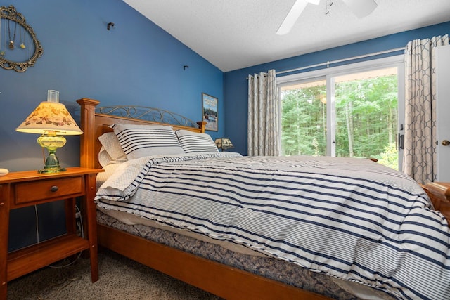 carpeted bedroom featuring vaulted ceiling, access to outside, a ceiling fan, and a textured ceiling
