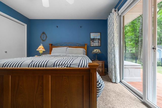 bedroom with carpet floors, access to outside, and a ceiling fan
