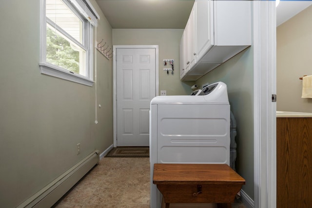 washroom featuring a baseboard radiator, cabinet space, washer and dryer, and baseboards