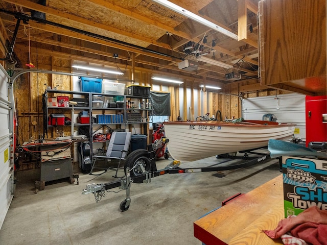 garage with a garage door opener and a workshop area