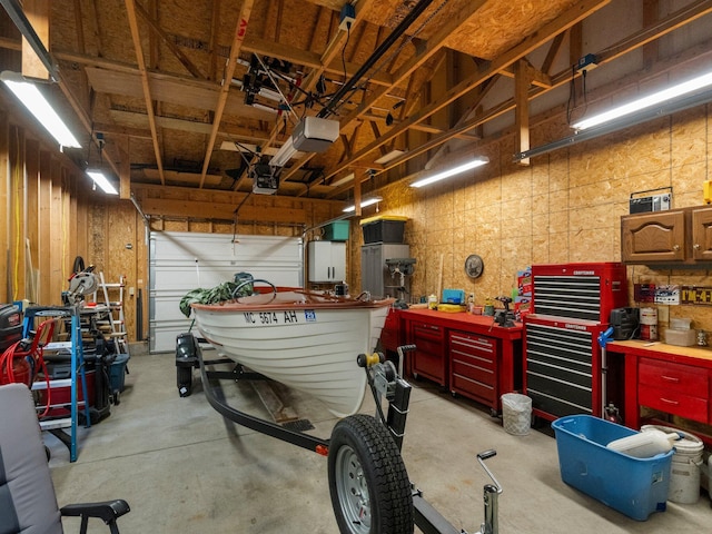 garage with a workshop area and a garage door opener