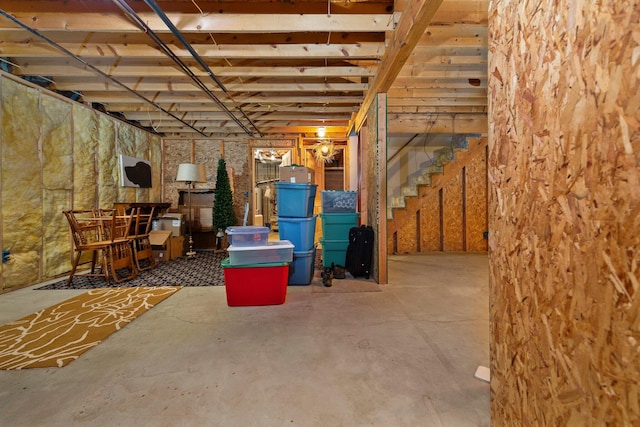 unfinished basement featuring stairs