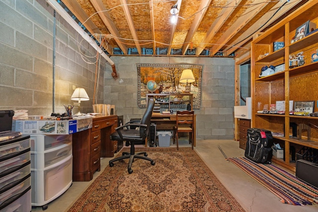 office area with concrete flooring and concrete block wall