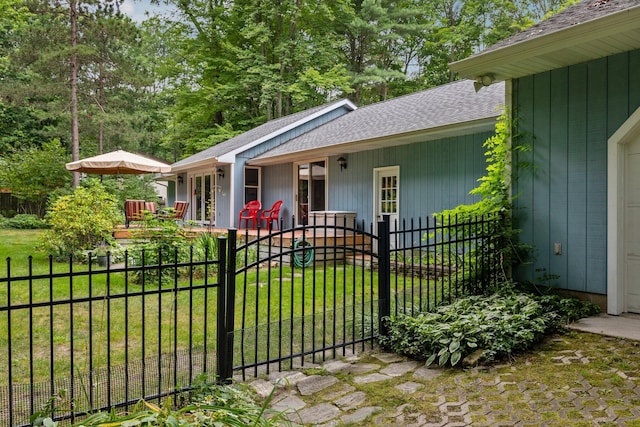 view of front of house featuring a porch, roof with shingles, and a gate