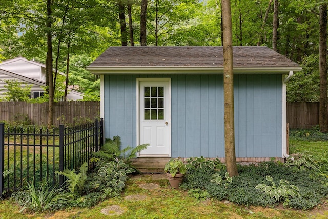 view of shed featuring fence