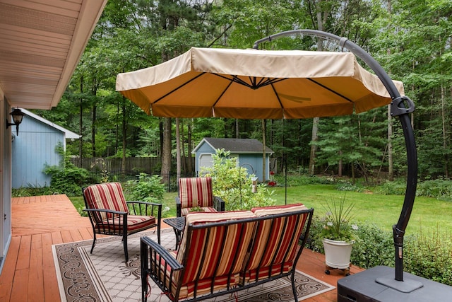 wooden deck with an outbuilding, view of scattered trees, a storage unit, and outdoor lounge area