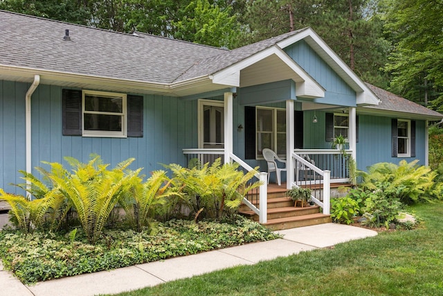 view of front of house featuring a shingled roof and covered porch