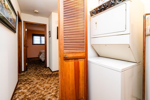 5410 Country Aire Dr Unit 14, Coloma, MI 49038 - clothes washing area with stacked washer and clothes dryer, dark colored carpet, and a textured ceiling