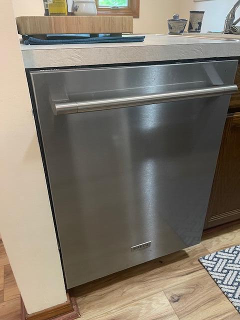 5410 Country Aire Dr Unit 14, Coloma, MI 49038 - kitchen view of stainless steel dishwasher and light wood-type flooring
