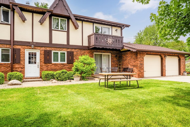 5410 Country Aire Dr Unit 14, Coloma, MI 49038 - view of front facade with a front lawn, a balcony, brick siding, and driveway