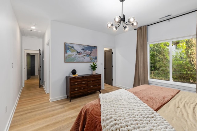 3500 Lakeshore Dr, Saint Joseph, MI 49085 - bedroom featuring light wood-style floors, baseboards, a chandelier, and attic access