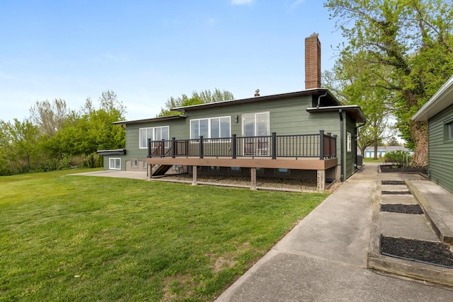 3500 Lakeshore Dr, Saint Joseph, MI 49085 - back of property with a chimney, a deck, and a yard