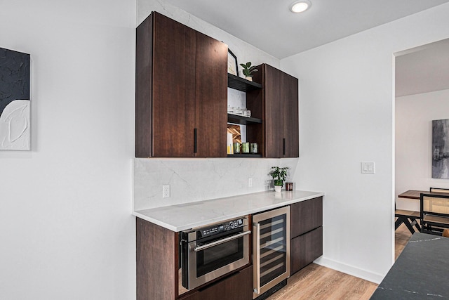 3500 Lakeshore Dr, Saint Joseph, MI 49085 - kitchen featuring open shelves, beverage cooler, dark brown cabinets, light wood finished floors, and oven