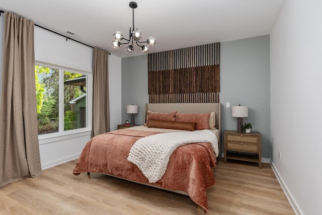 3500 Lakeshore Dr, Saint Joseph, MI 49085 - bedroom featuring light wood finished floors, a chandelier, and baseboards