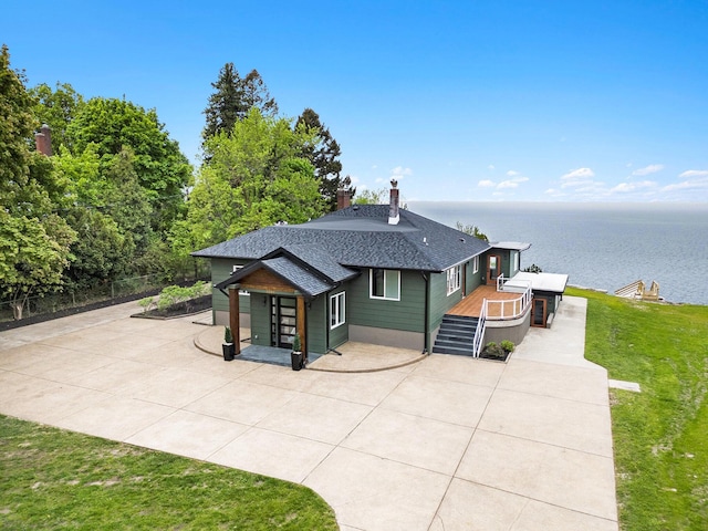 3500 Lakeshore Dr, Saint Joseph, MI 49085 - back of house with roof with shingles, a chimney, a patio area, and a deck with water view