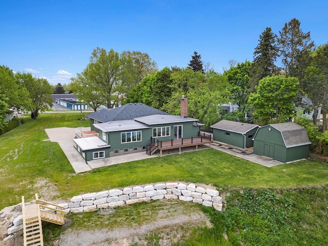 3500 Lakeshore Dr, Saint Joseph, MI 49085 - back of house featuring a deck, a patio, a shed, an outbuilding, and a chimney