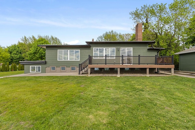 3500 Lakeshore Dr, Saint Joseph, MI 49085 - back of house featuring a chimney, a deck, and a yard