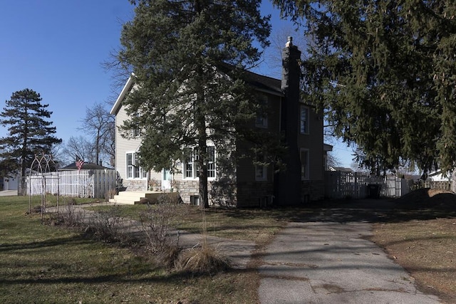2106 Forest, Portage, MI 49002 - view of property exterior with stone siding and fence
