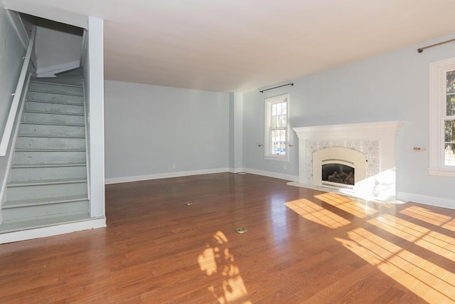 2106 Forest, Portage, MI 49002 - unfurnished living room featuring plenty of natural light, stairway, wood finished floors, and a high end fireplace