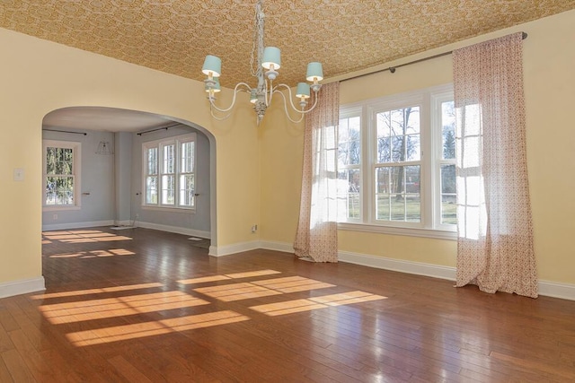 2106 Forest, Portage, MI 49002 - unfurnished room with arched walkways, hardwood / wood-style flooring, a chandelier, baseboards, and an ornate ceiling