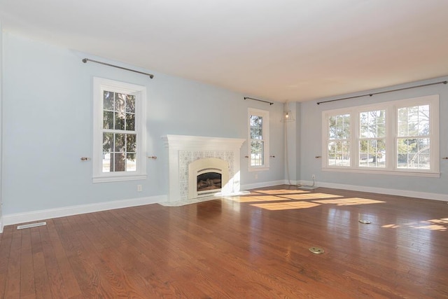 2106 Forest, Portage, MI 49002 - unfurnished living room featuring wood finished floors, baseboards, and a high end fireplace