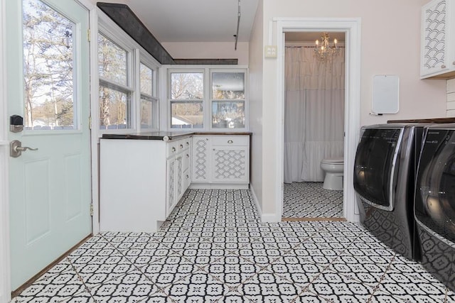 2106 Forest, Portage, MI 49002 - washroom with washing machine and dryer and a chandelier