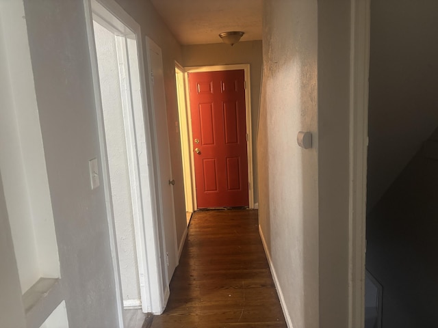 20100 Wexford St, Detroit, MI 48234 - corridor featuring dark wood-style floors, baseboards, and a textured wall
