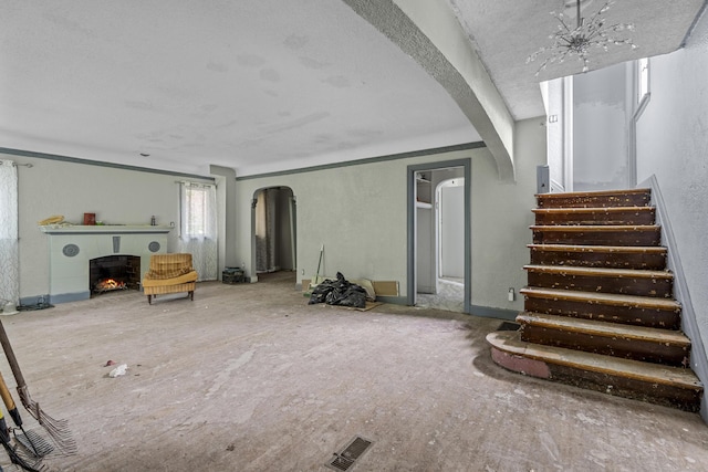 16634 Parkside St, Detroit, MI 48221 - basement featuring arched walkways, stairway, and a lit fireplace