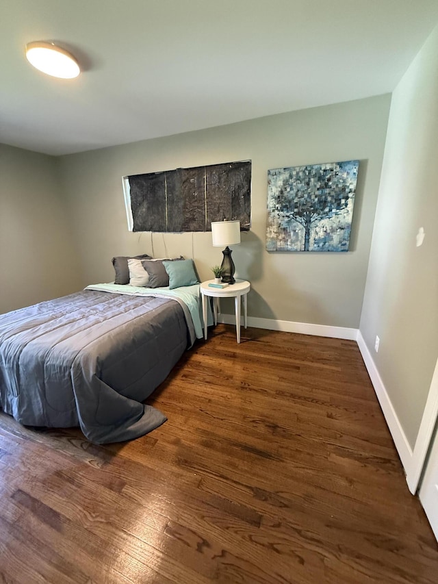 bedroom featuring wood finished floors and baseboards