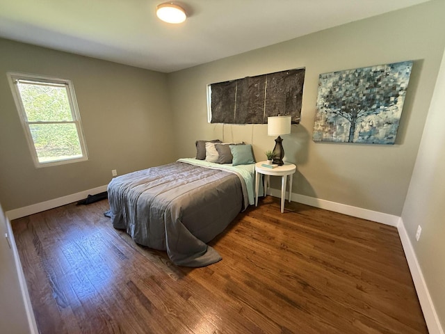 bedroom featuring wood finished floors and baseboards