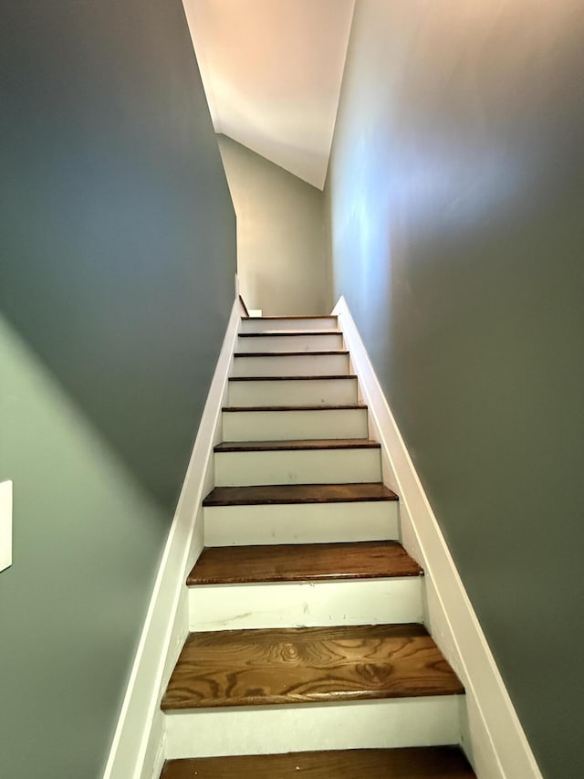 staircase featuring lofted ceiling