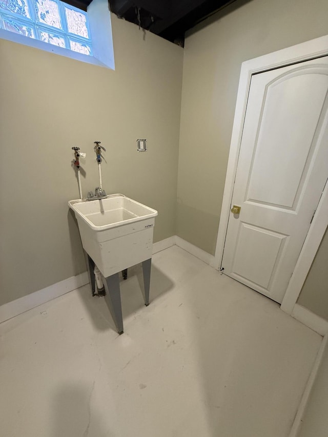 bathroom with concrete floors and baseboards