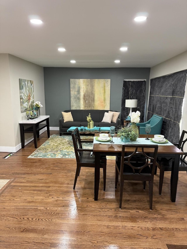 dining area featuring recessed lighting, wood finished floors, and baseboards