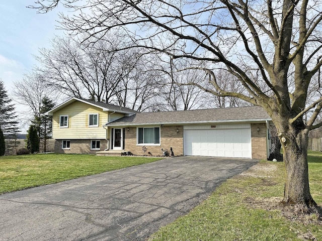 2565 Carleton Rockwood Rd, Carleton, MI 48117 - split level home with driveway, brick siding, an attached garage, and a front lawn