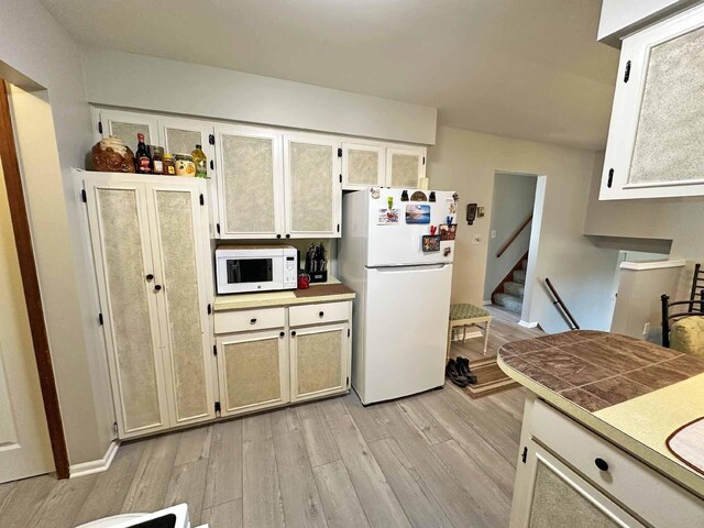 2565 Carleton Rockwood Rd, Carleton, MI 48117 - kitchen featuring white appliances and light wood-type flooring