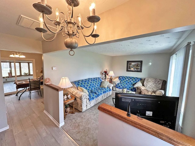 2565 Carleton Rockwood Rd, Carleton, MI 48117 - living area with a chandelier, wood finished floors, and baseboards
