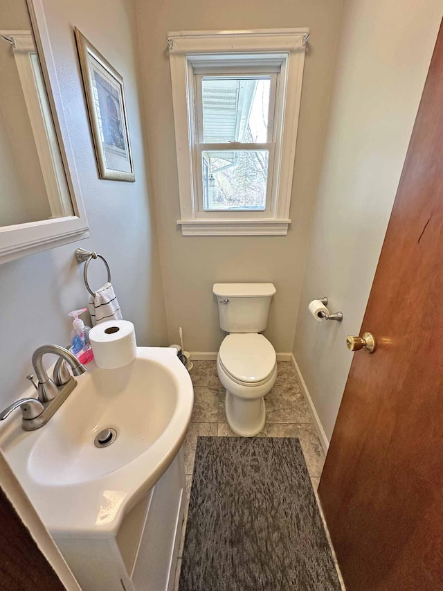 2565 Carleton Rockwood Rd, Carleton, MI 48117 - half bathroom with toilet, baseboards, vanity, and tile patterned flooring
