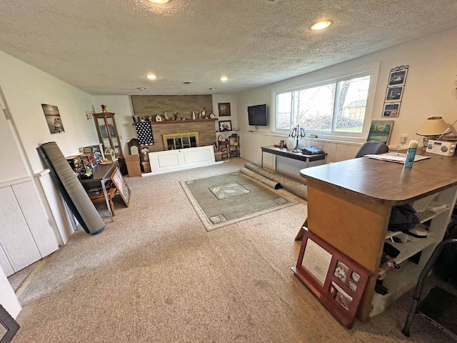 2565 Carleton Rockwood Rd, Carleton, MI 48117 - living room with a textured ceiling, carpet flooring, wainscoting, a fireplace, and recessed lighting