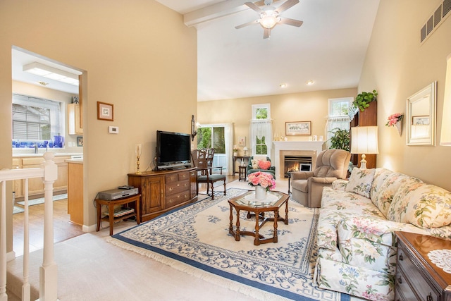 7343 Green Meadow Ln, Canton, MI 48187 - living room featuring ceiling fan, high vaulted ceiling, a warm lit fireplace, light colored carpet, and beamed ceiling
