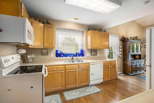 7343 Green Meadow Ln, Canton, MI 48187 - kitchen with white appliances, a sink, light wood-type flooring, light countertops, and vaulted ceiling