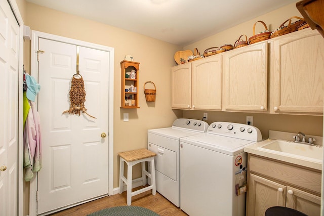 7343 Green Meadow Ln, Canton, MI 48187 - clothes washing area featuring cabinet space, washer and dryer, and light wood-style flooring
