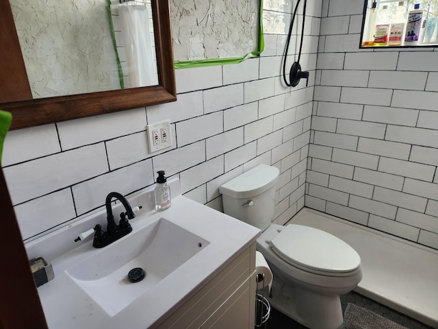 13851 Hillsdale Rd, Camden, MI 49232 - full bath featuring tile walls, a shower stall, toilet, vanity, and tasteful backsplash
