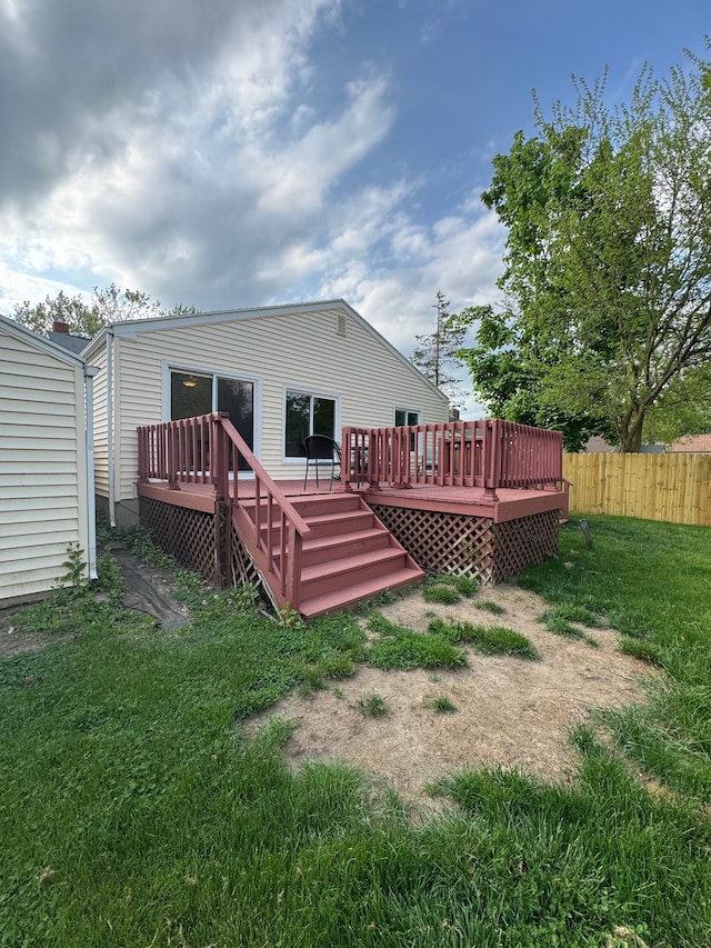 rear view of property featuring a wooden deck