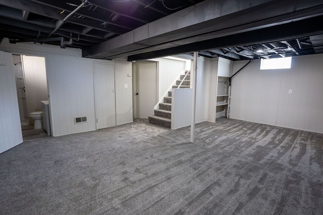 below grade area featuring carpet and stairs