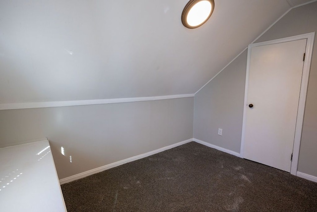 additional living space with vaulted ceiling, carpet floors, and baseboards