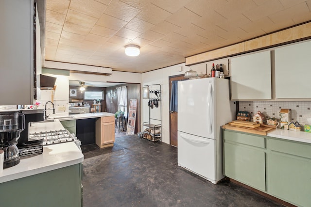 27 Hawley St, Quincy, MI 49082 - kitchen featuring green cabinetry, freestanding refrigerator, finished concrete flooring, and tasteful backsplash