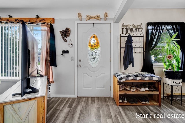 foyer entrance with wood finished floors and baseboards