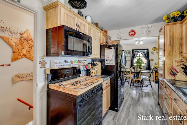 kitchen with black appliances, light brown cabinets, and light wood-type flooring