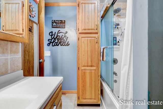 bathroom featuring bath / shower combo with glass door and tile patterned flooring